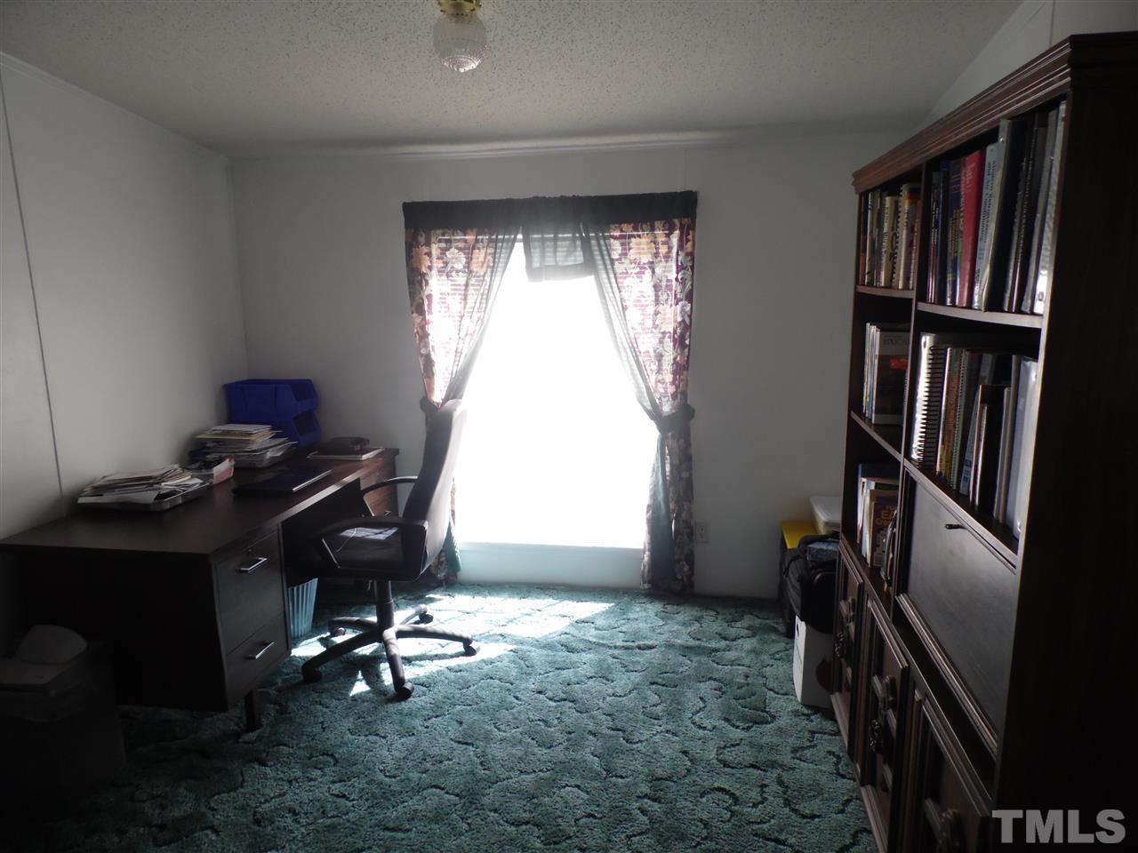 10582 Cone Road Middlesex, NC 27557 - Photo 14 of 25 a workspace with furniture bookshelf and a window