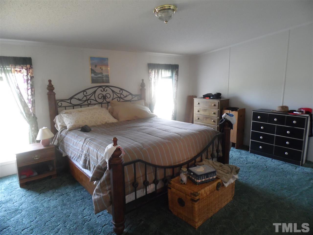10582 Cone Road Middlesex, NC 27557 - Photo 16 of 25 a bedroom with a bed a couch and dresser