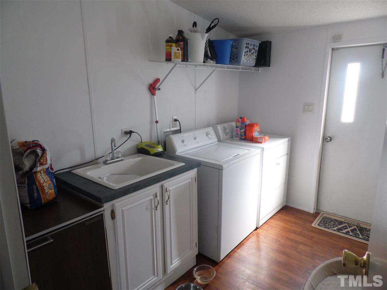 10582 Cone Road Middlesex, NC 27557 - Photo 20 of 25 a utility room with sink dryer and washer