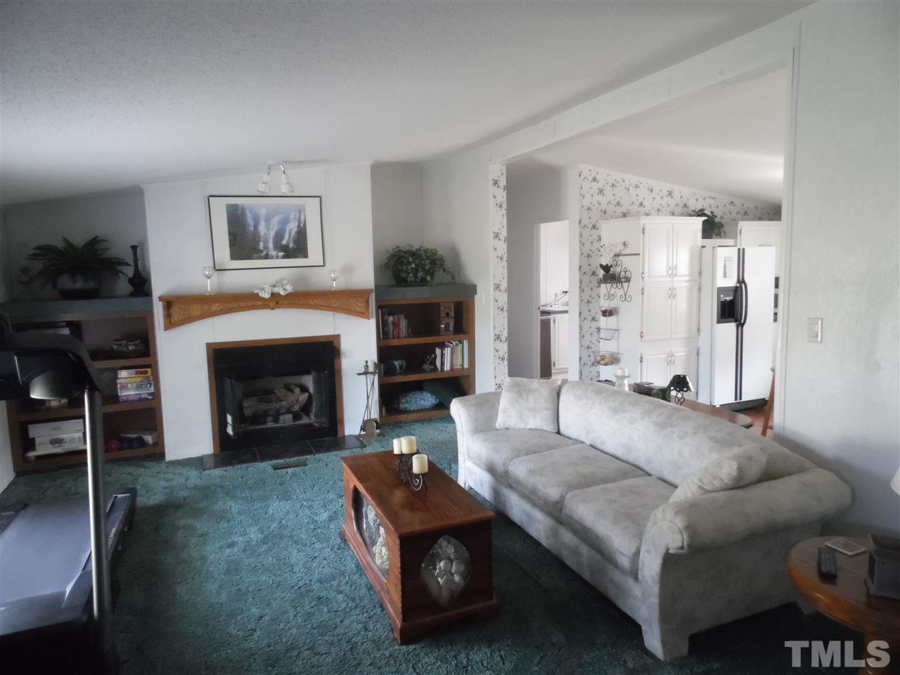10582 Cone Road Middlesex, NC 27557 - Photo 3 of 25 a living room with furniture and a fireplace