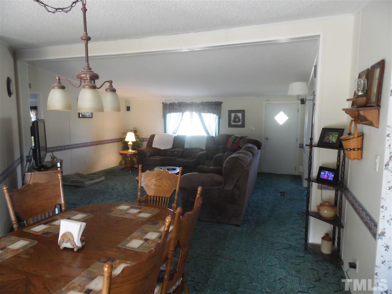 10582 Cone Road Middlesex, NC 27557 - Photo 6 of 25 a living room with furniture a flat screen tv and a window