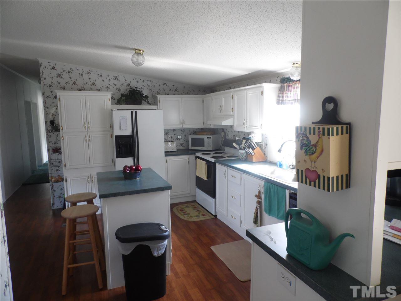 10582 Cone Road Middlesex, NC 27557 - Photo 8 of 25 a kitchen with cabinets a sink and appliances