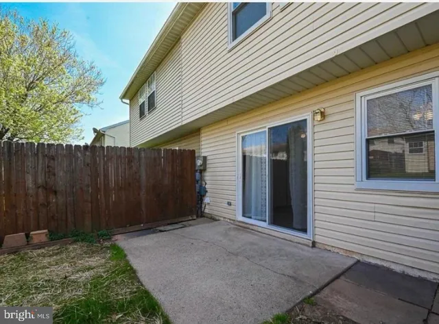 a view of wooden house with wooden fence