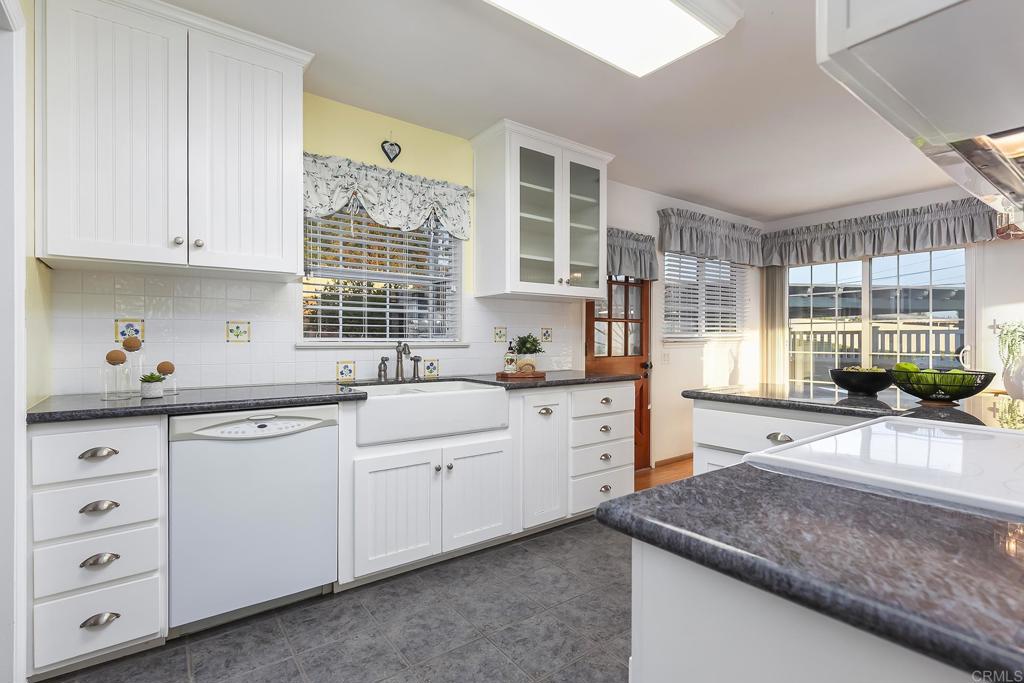 1407 Cascade Place El Cajon, CA 92021 - Photo 8 of 43 a kitchen with cabinets appliances and a window