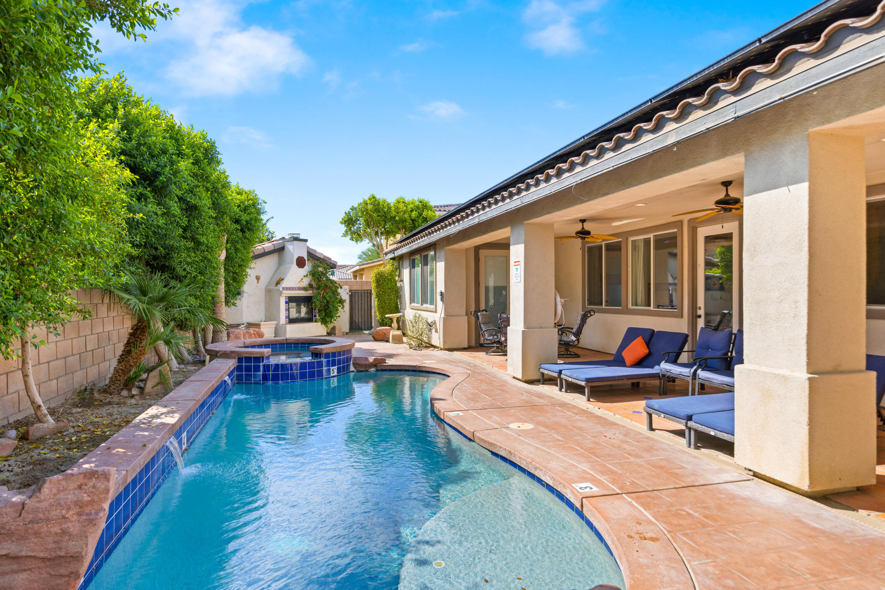 a view of a patio with swimming pool table and chairs