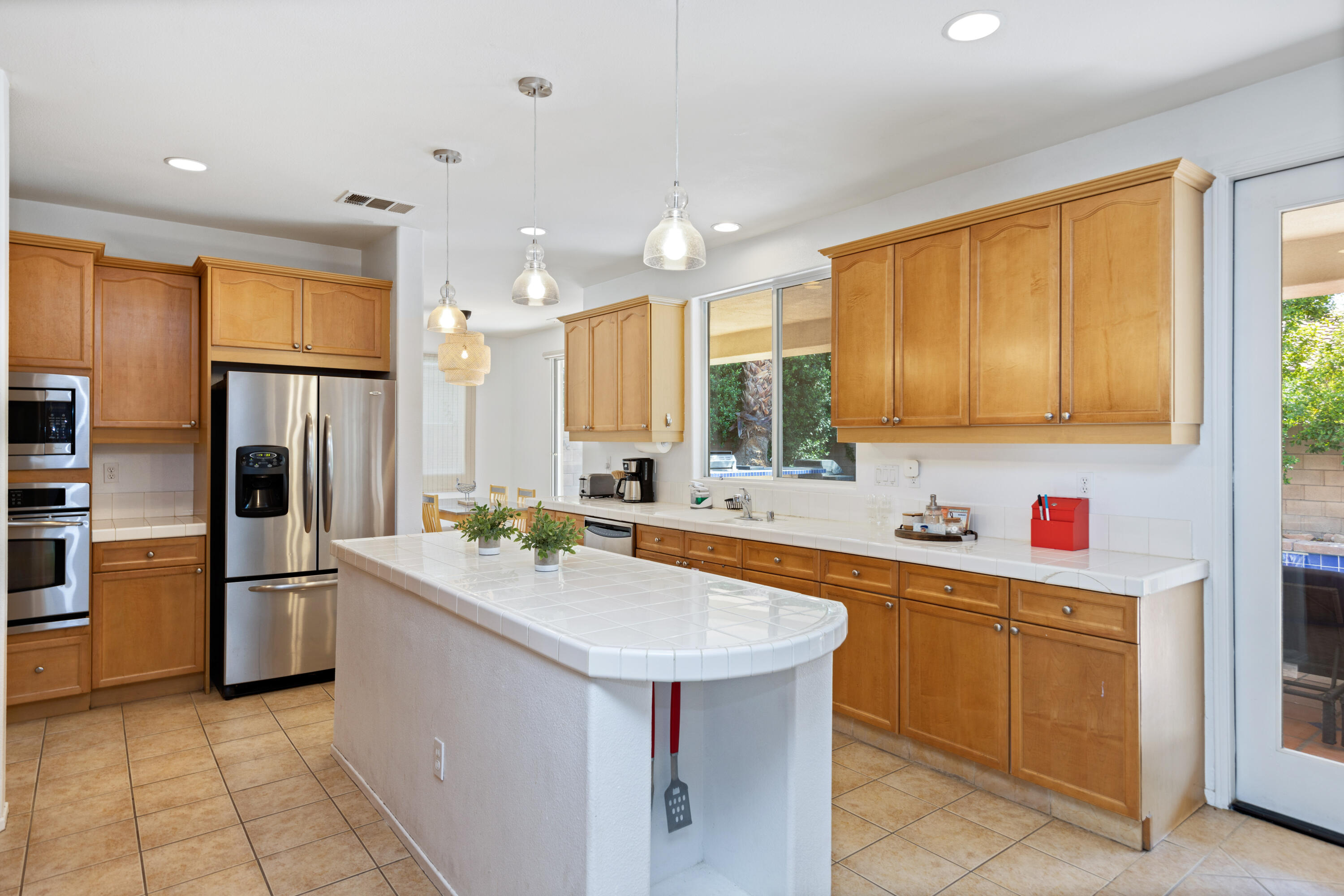 83299 Stagecoach Road Indio, CA 92203 - Photo 11 of 44 a kitchen with stainless steel appliances granite countertop a sink stove refrigerator and cabinets