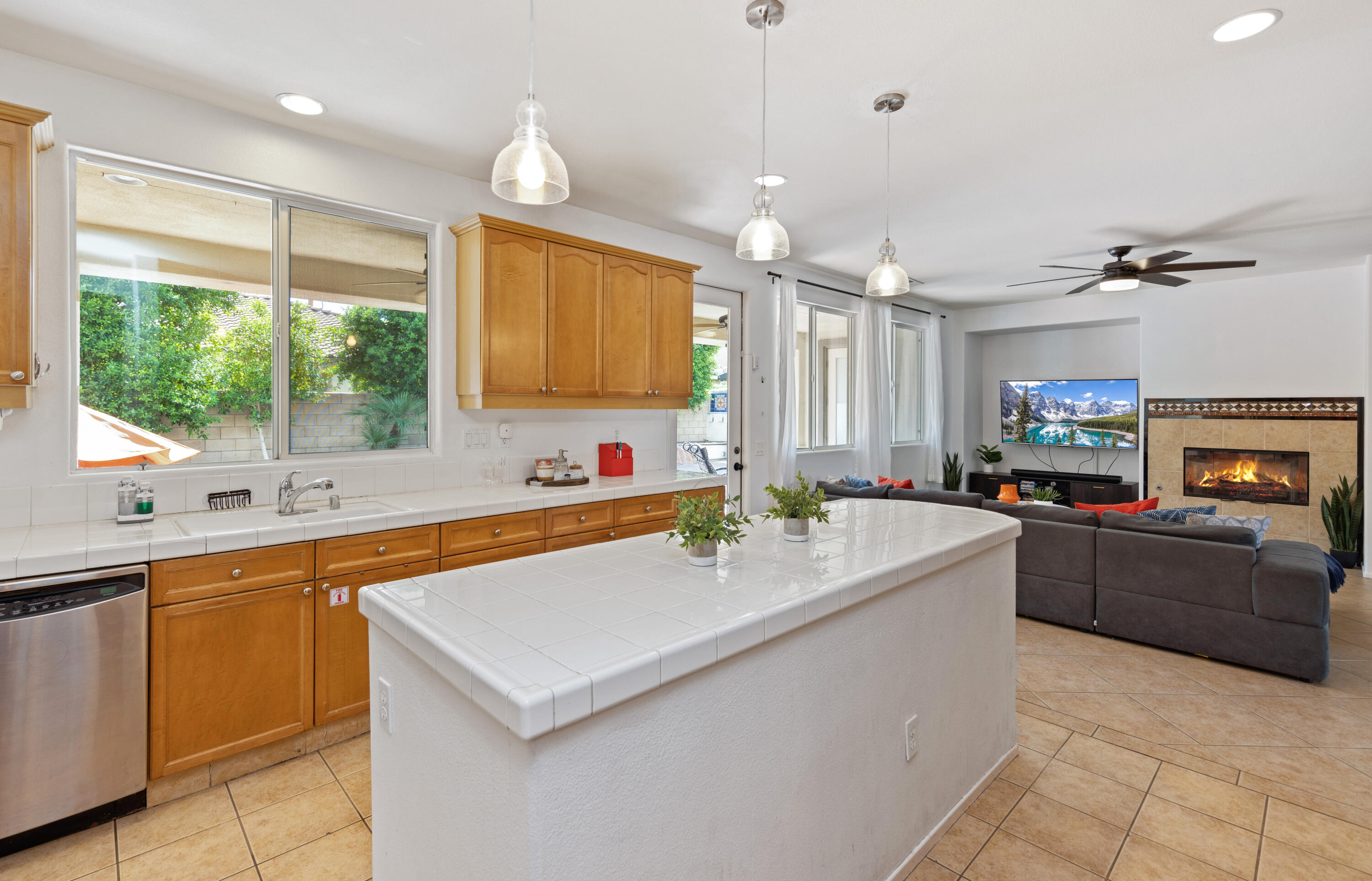 83299 Stagecoach Road Indio, CA 92203 - Photo 13 of 44 a kitchen with kitchen island granite countertop a sink a counter top space appliances and a window
