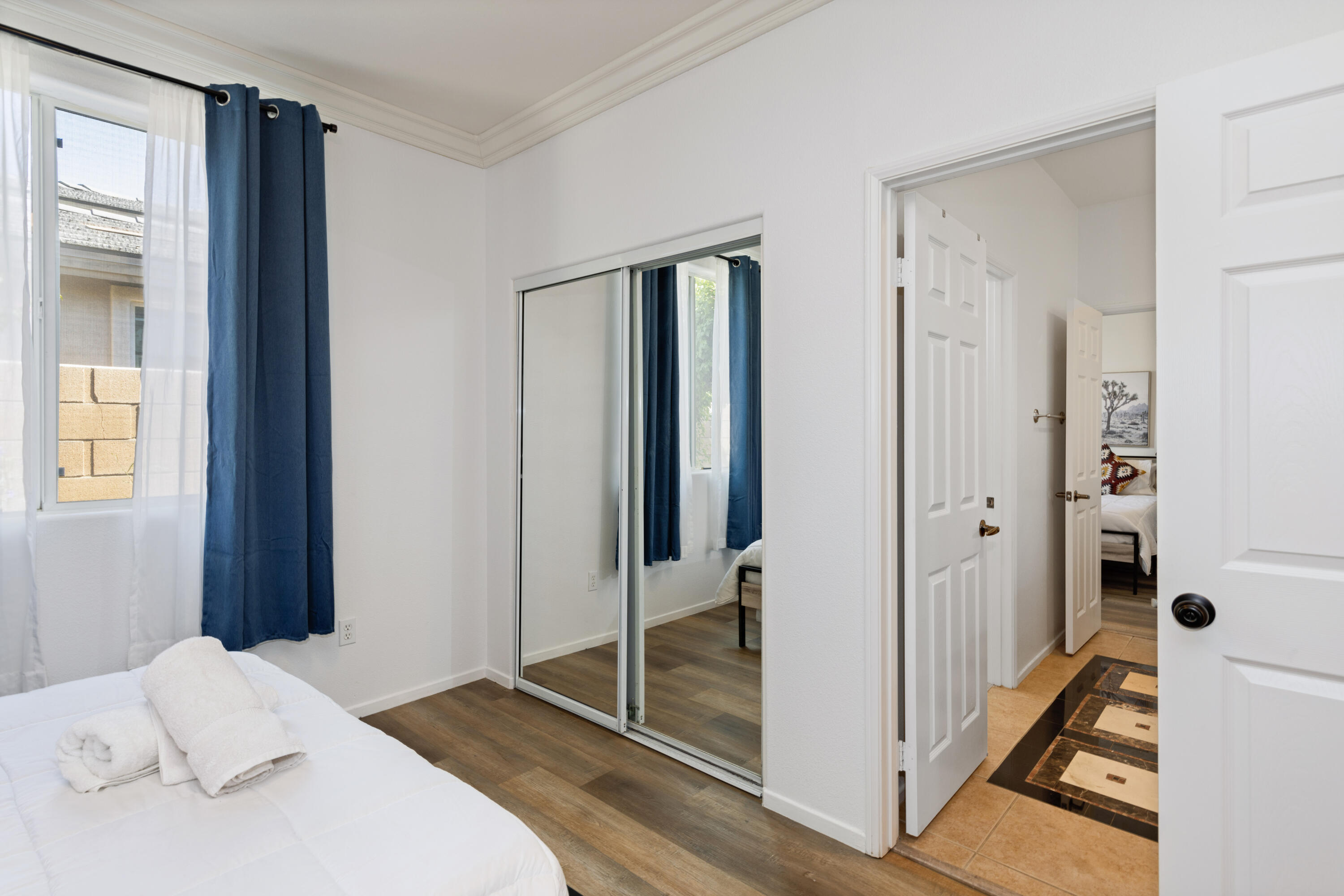 83299 Stagecoach Road Indio, CA 92203 - Photo 26 of 44 a bedroom with a bed and a glass door shower