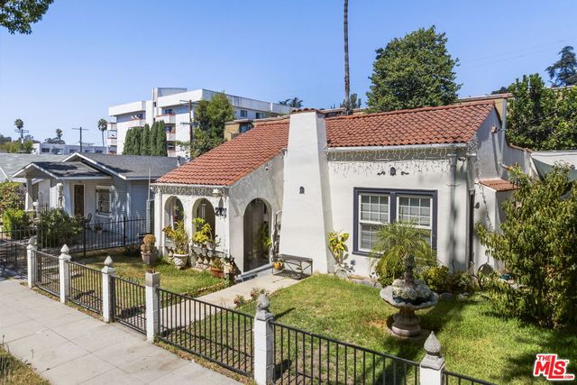 a view of a house with wooden fence