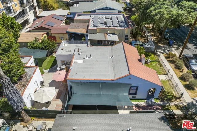 an aerial view of a house with garden space and street view