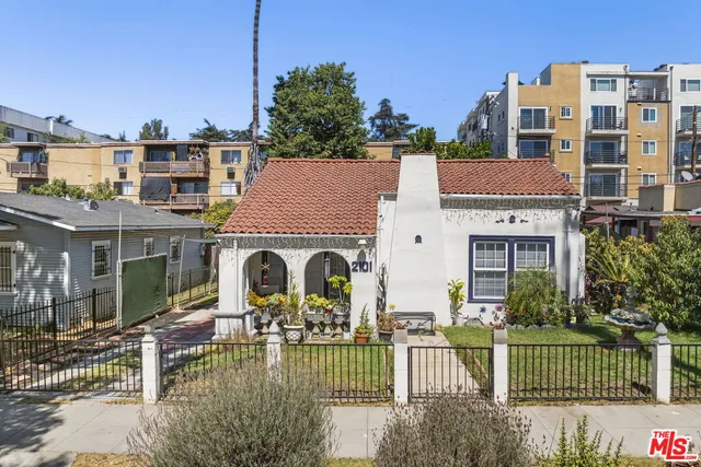a view of house with outdoor space and swimming pool