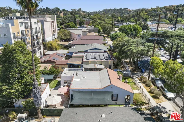an aerial view of a house with a yard