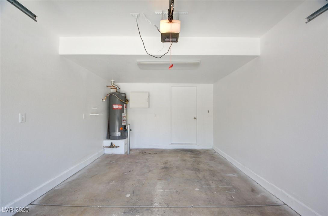 10138 Rocky Tree Street Las Vegas, NV 89183 - Photo 15 of 43 Garage with gas water heater and a garage door opener