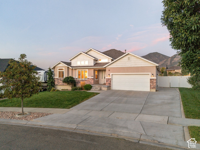 1288 North Horizon View Loop Elk Ridge, UT 84651 - Photo 29 of 38 Exterior featuring a two-car garage, stone and stucco facade, and a concrete driveway