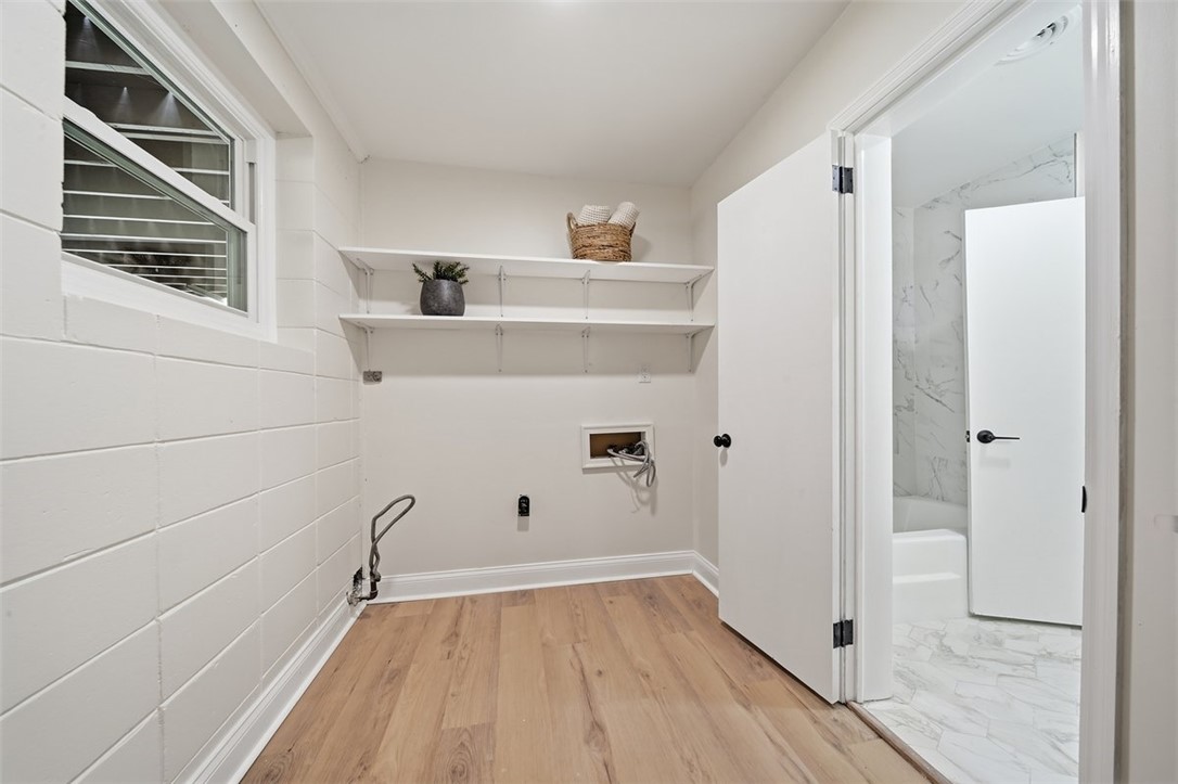 107 Edwards Mill Road Taylors, SC 29687 - Photo 24 of 34 Functional laundry space with ample shelving and durable flooring awaits your personal touch.