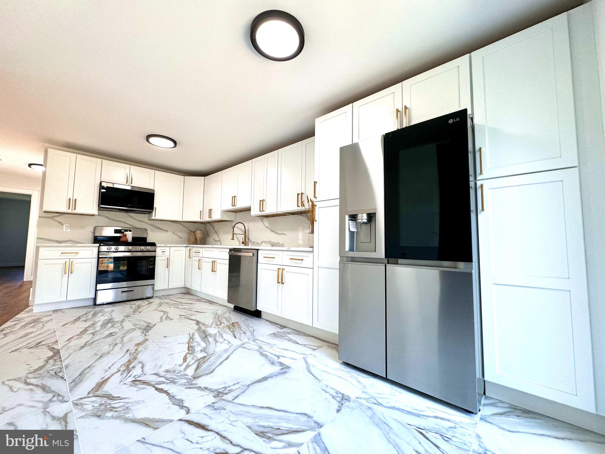 3 Mint Leaf Drive Hamilton, NJ 08690 - Photo 12 of 33 a kitchen with granite countertop a refrigerator and a sink