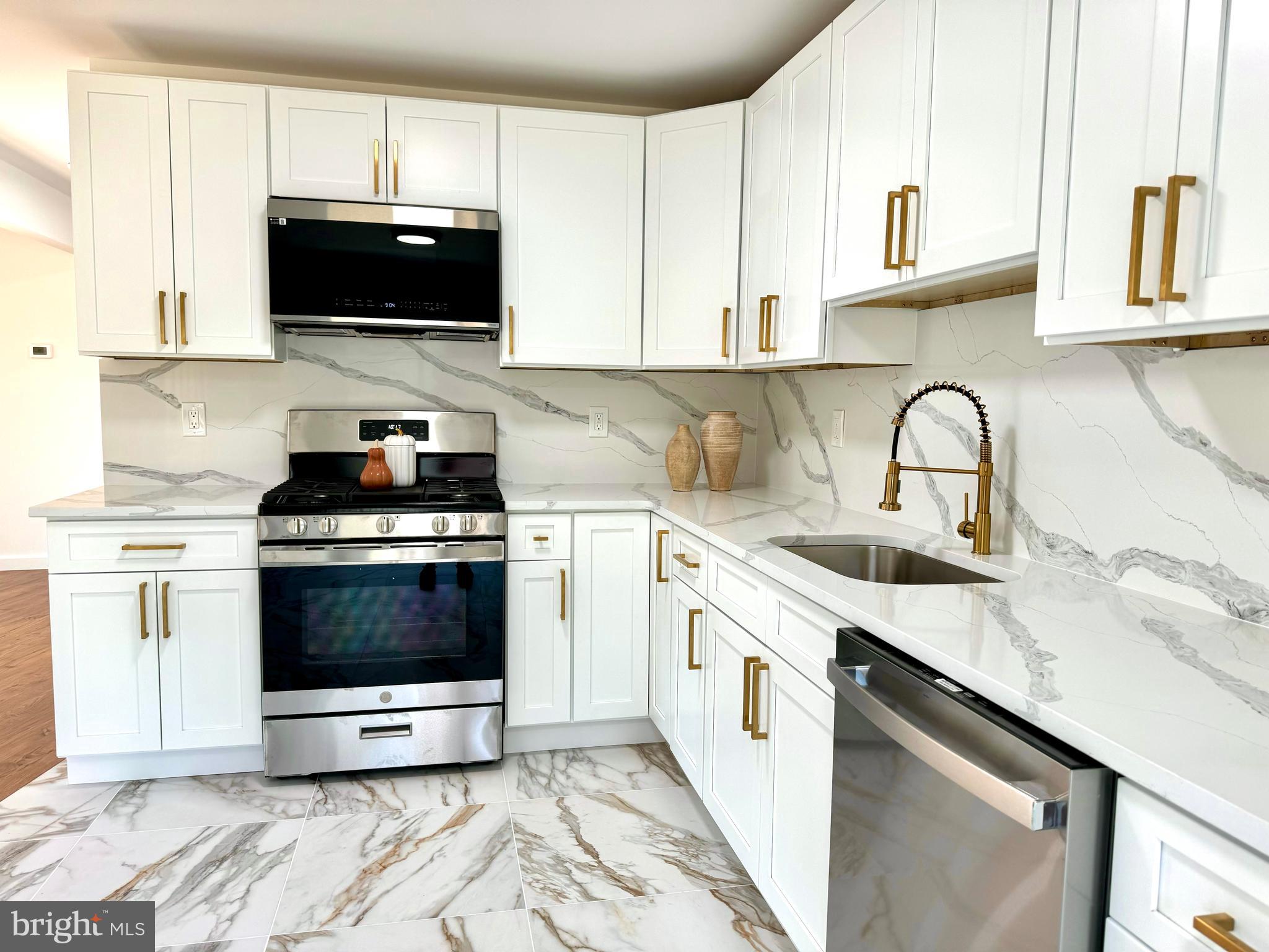 3 Mint Leaf Drive Hamilton, NJ 08690 - Photo 8 of 33 a kitchen with stainless steel appliances a stove a sink a microwave and cabinets