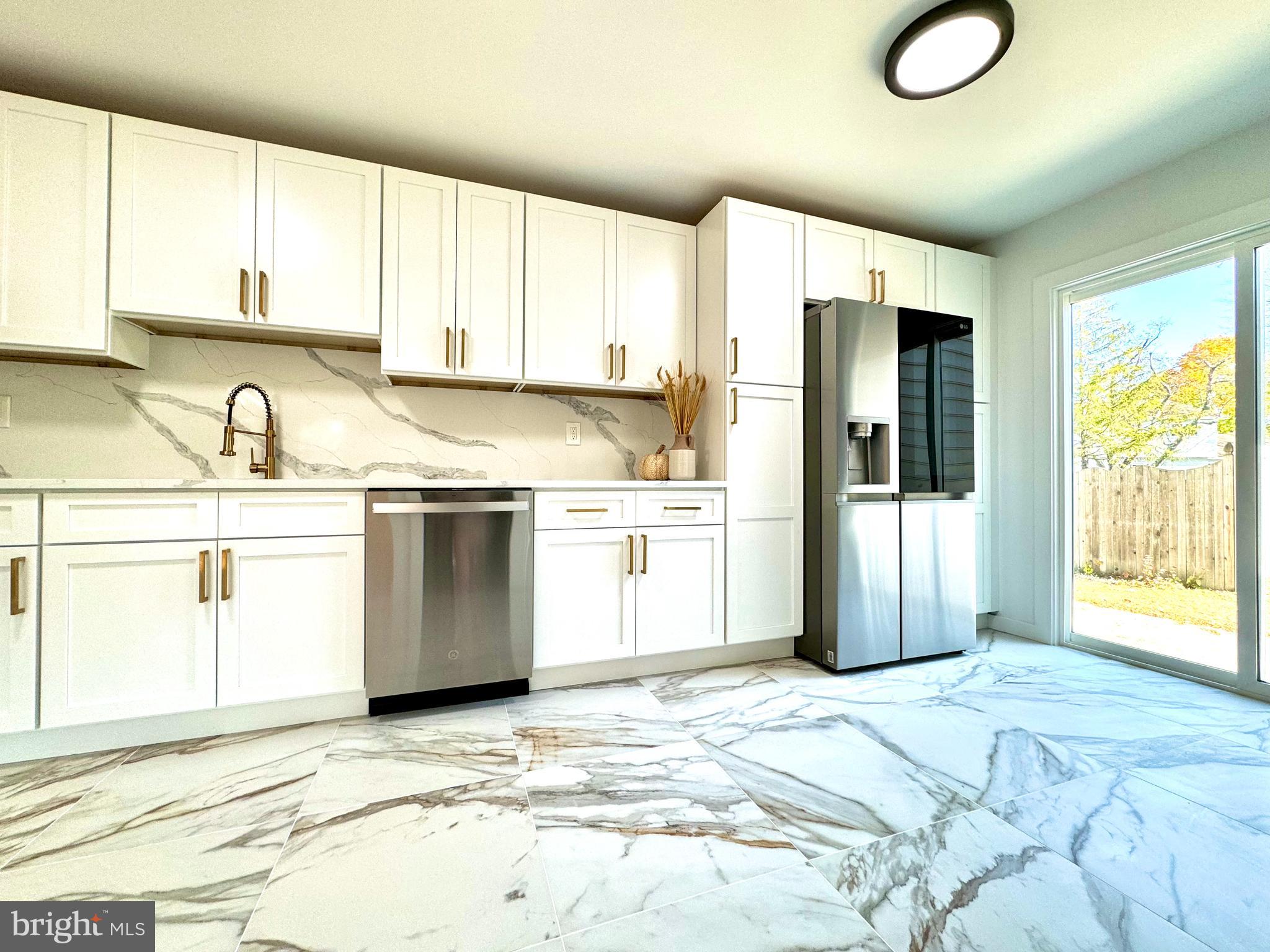 3 Mint Leaf Drive Hamilton, NJ 08690 - Photo 10 of 33 a kitchen with stainless steel appliances granite countertop a refrigerator sink and cabinets