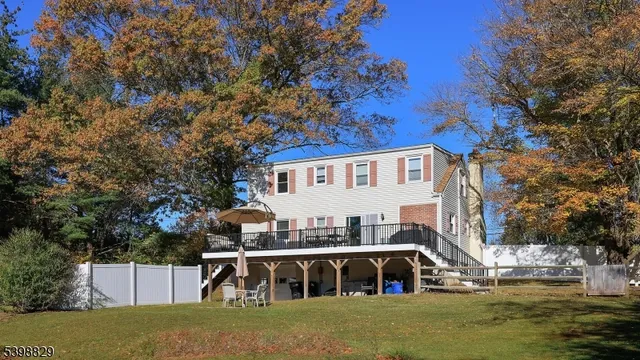 a view of a white house with a yard