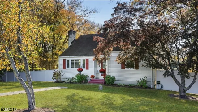 a living room with furniture a flat screen tv and a large window