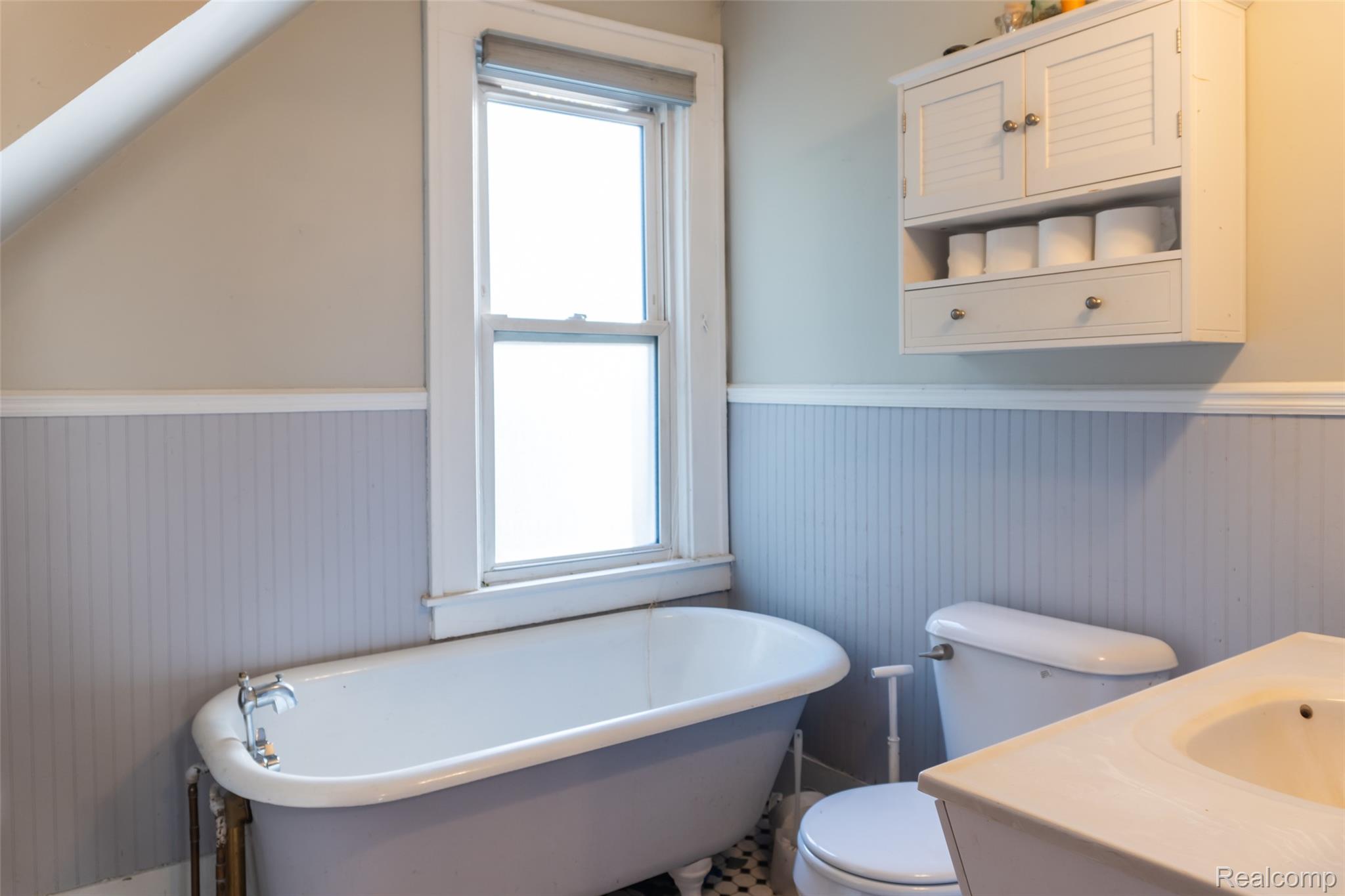 1846 North Gulley Road Dearborn, MI 48128 - Photo 15 of 32 Bathroom featuring wainscoting, a soaking tub, and vanity