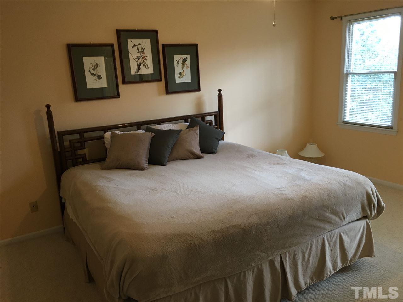 7329 Mill Ridge Road Raleigh, NC 27613 - Photo 12 of 25 a bedroom with a bed and wall painting