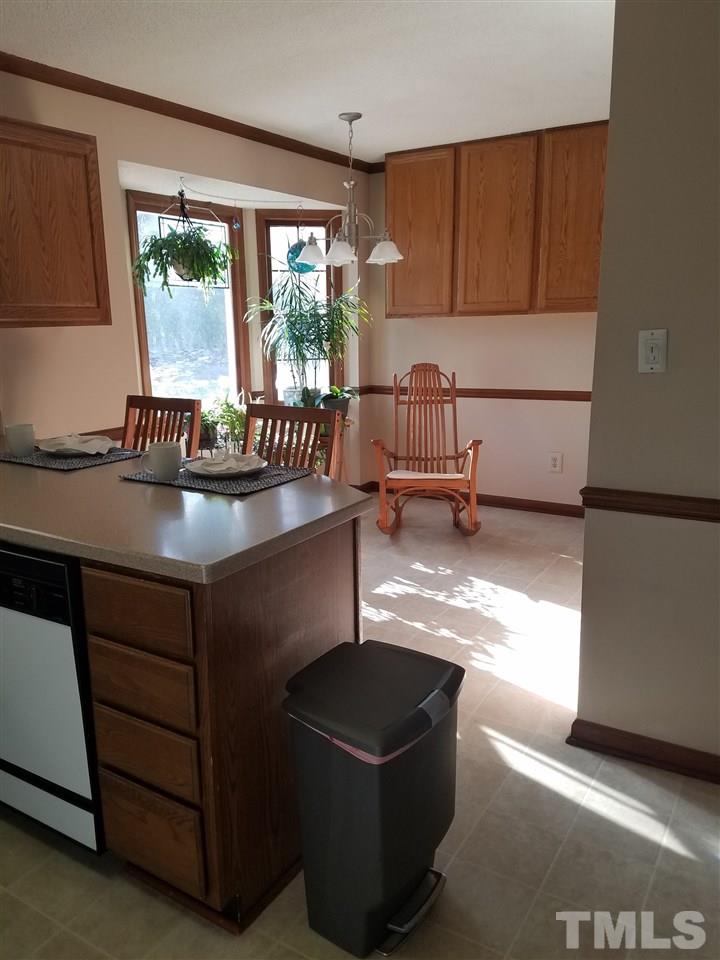 7329 Mill Ridge Road Raleigh, NC 27613 - Photo 14 of 25 a kitchen with granite countertop a stove a sink and a refrigerator