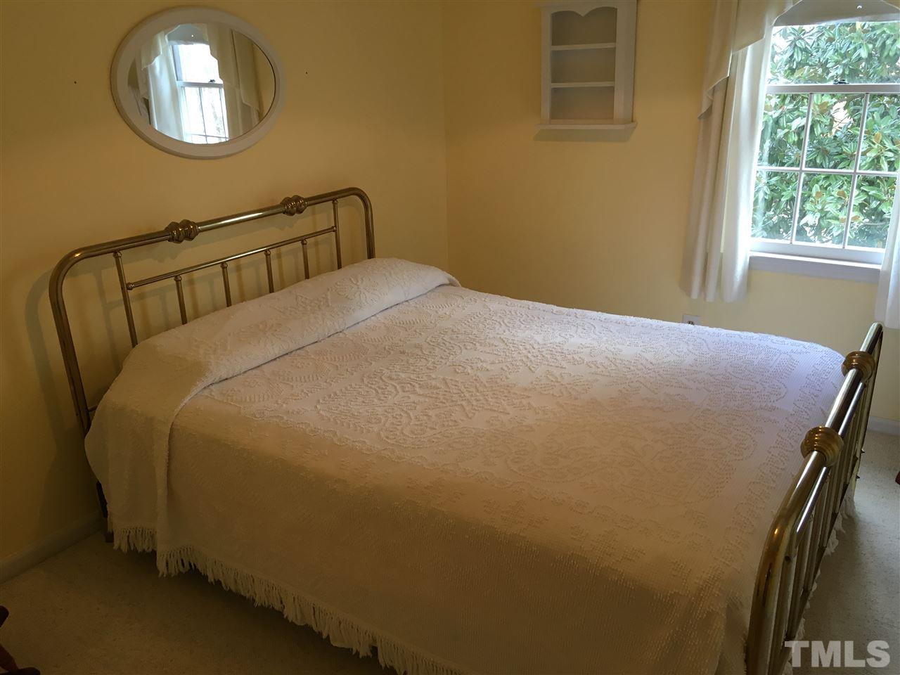 7329 Mill Ridge Road Raleigh, NC 27613 - Photo 15 of 25 a bedroom with a bed and window