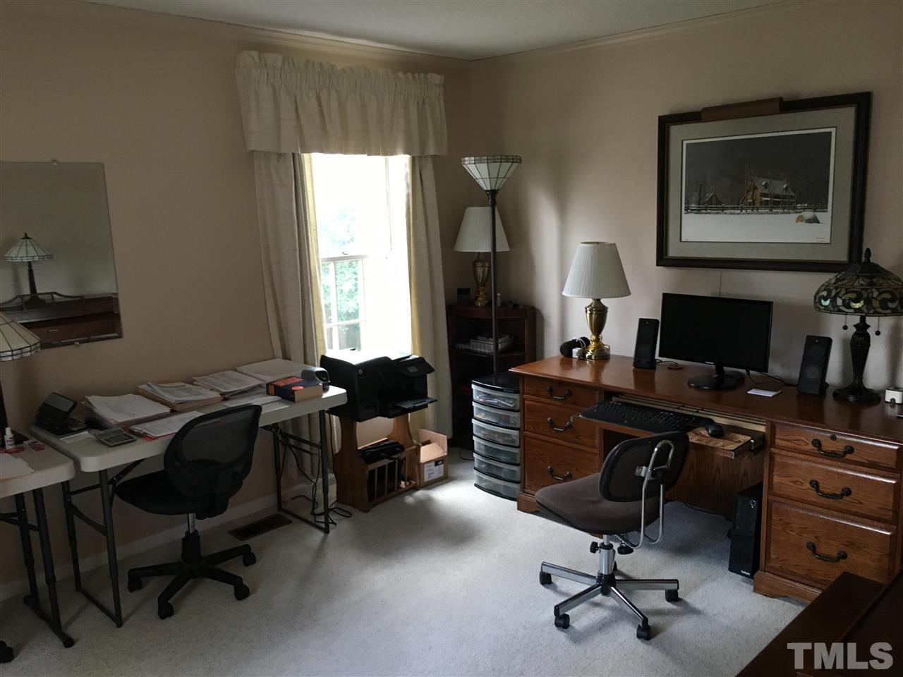 7329 Mill Ridge Road Raleigh, NC 27613 - Photo 18 of 25 a view of a workspace with furniture and a window