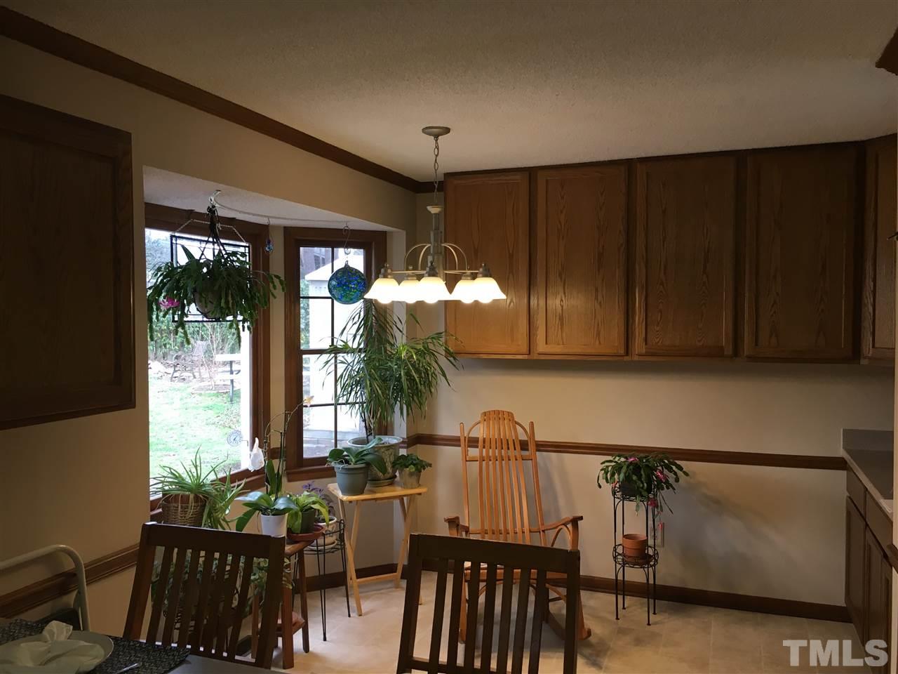 7329 Mill Ridge Road Raleigh, NC 27613 - Photo 20 of 25 a kitchen with furniture a window and a potted plant