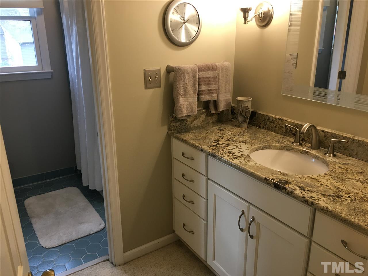 7329 Mill Ridge Road Raleigh, NC 27613 - Photo 21 of 25 a bathroom with a granite countertop sink and a mirror