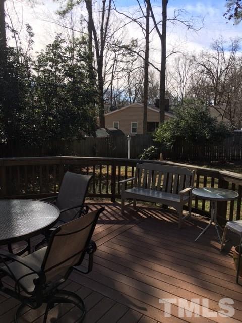 7329 Mill Ridge Road Raleigh, NC 27613 - Photo 24 of 25 a view of a roof deck with table and chairs and wooden floor