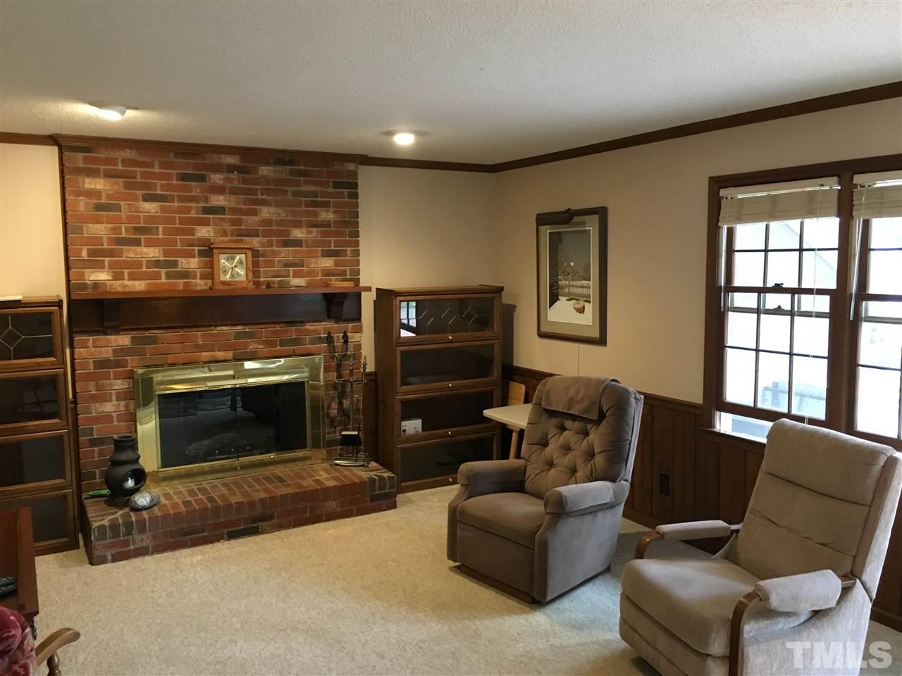 7329 Mill Ridge Road Raleigh, NC 27613 - Photo 8 of 25 a living room with furniture a flat screen tv and a fireplace