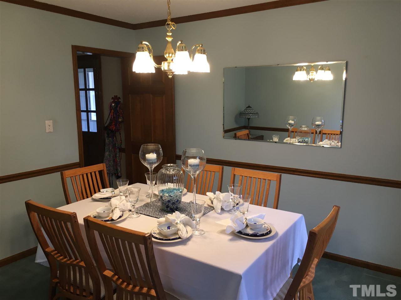 7329 Mill Ridge Road Raleigh, NC 27613 - Photo 10 of 25 a view of a dining room with furniture and wooden floor