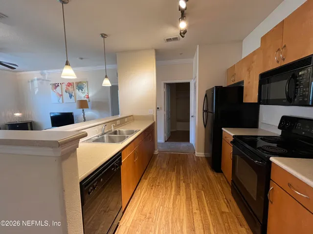 a bed sitting in a spacious bedroom next to a window