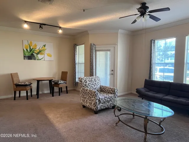 a living room with furniture and a large window