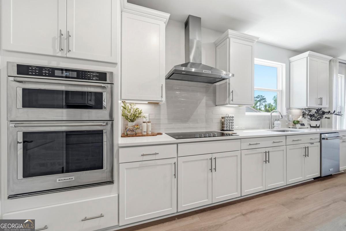 1190 Little Shls Road Greensboro, GA 30642 - Photo 13 of 44 a kitchen with white cabinets and appliances