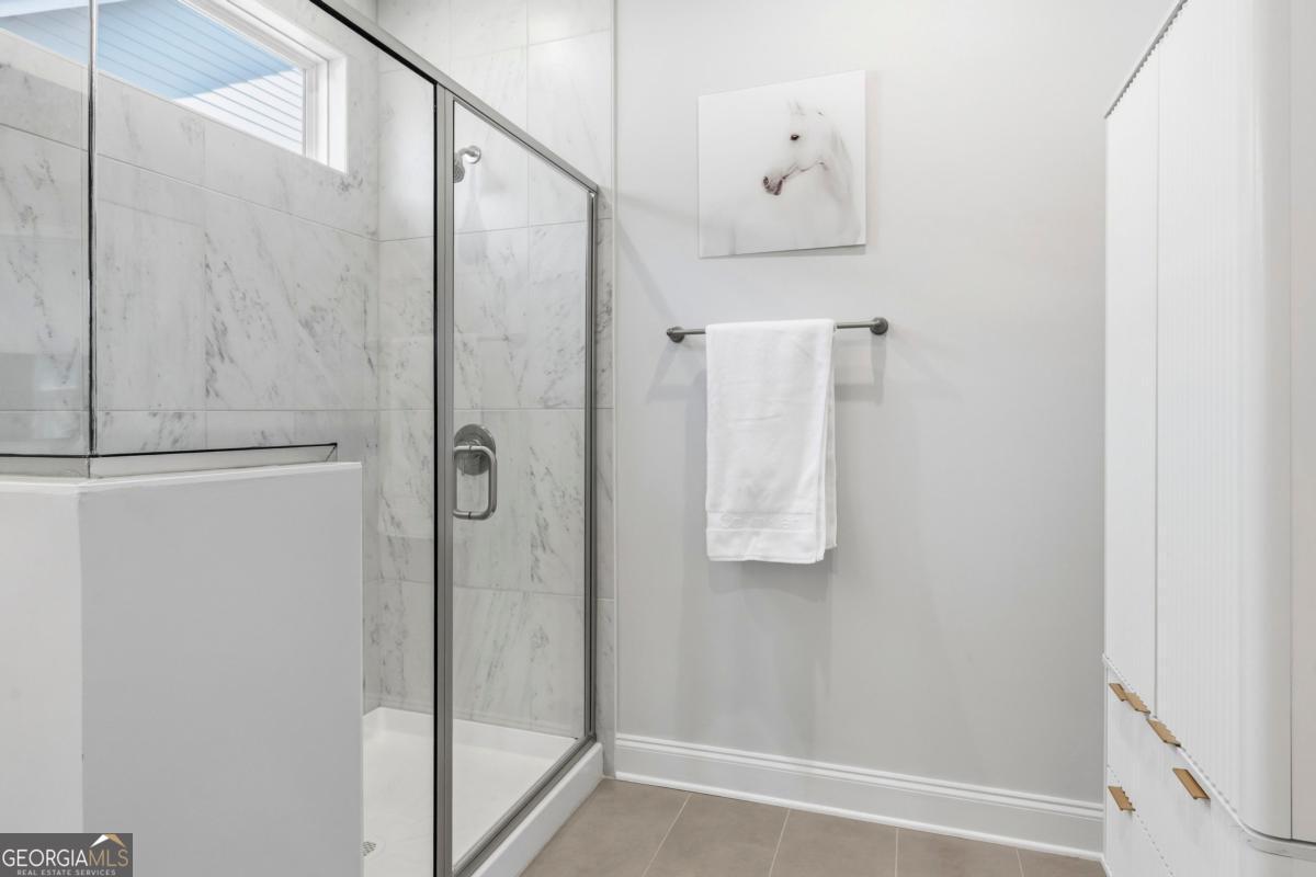 1190 Little Shls Road Greensboro, GA 30642 - Photo 24 of 44 a bathroom with a shower and mirror