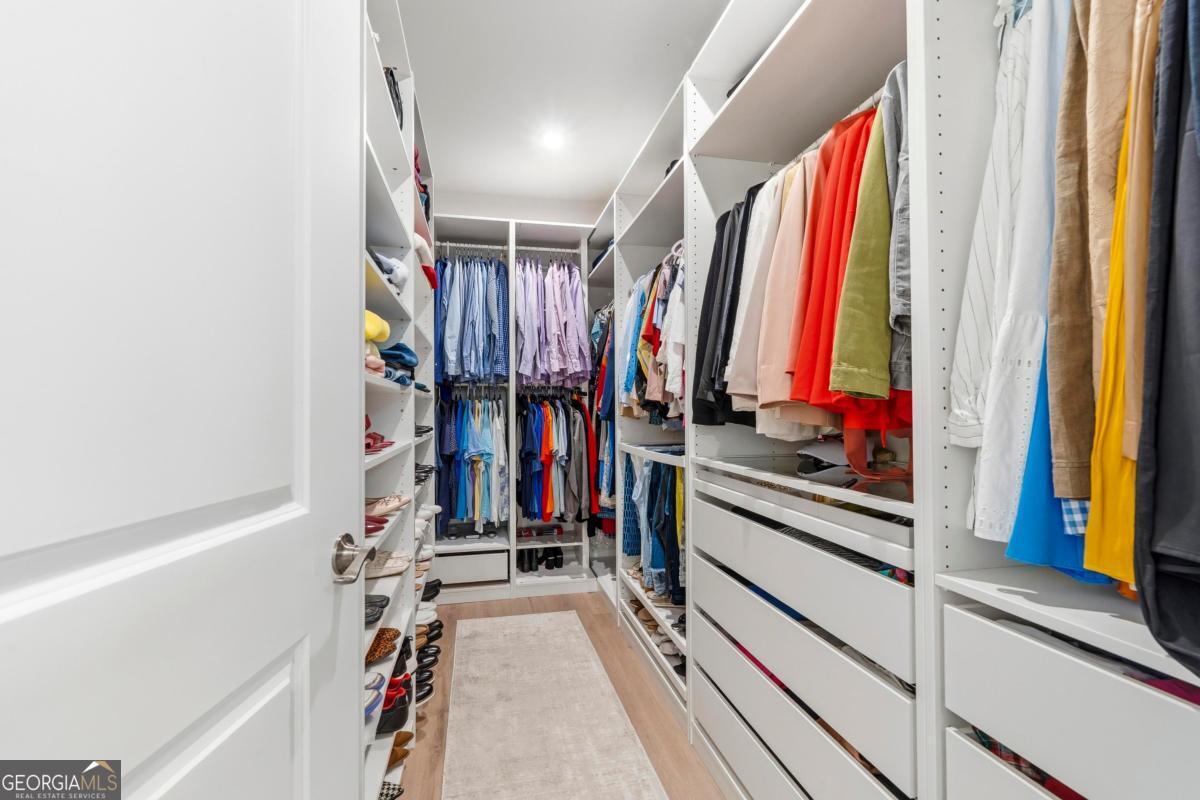 1190 Little Shls Road Greensboro, GA 30642 - Photo 26 of 44 a view of walk in closet with clothes and shoes