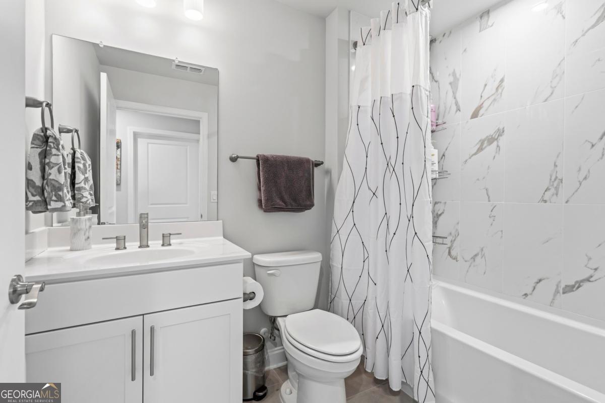 1190 Little Shls Road Greensboro, GA 30642 - Photo 30 of 44 a bathroom with a toilet sink vanity tub and mirror