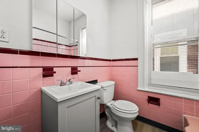 a bathroom with a sink a toilet and mirror