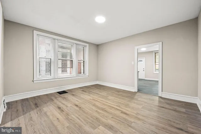 wooden floor in an empty room with a window