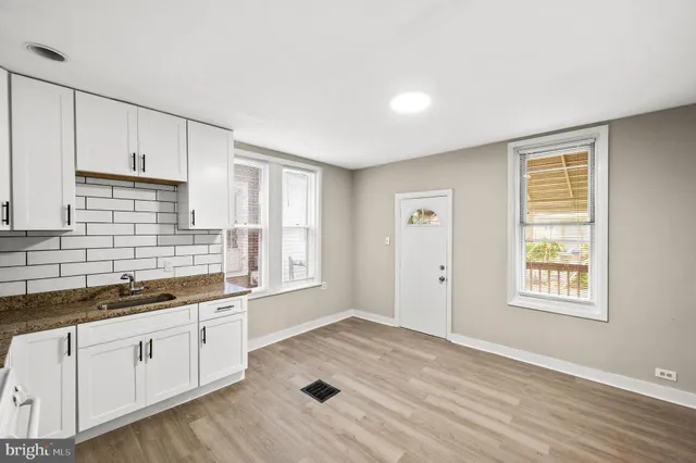 a kitchen with a sink window and cabinets