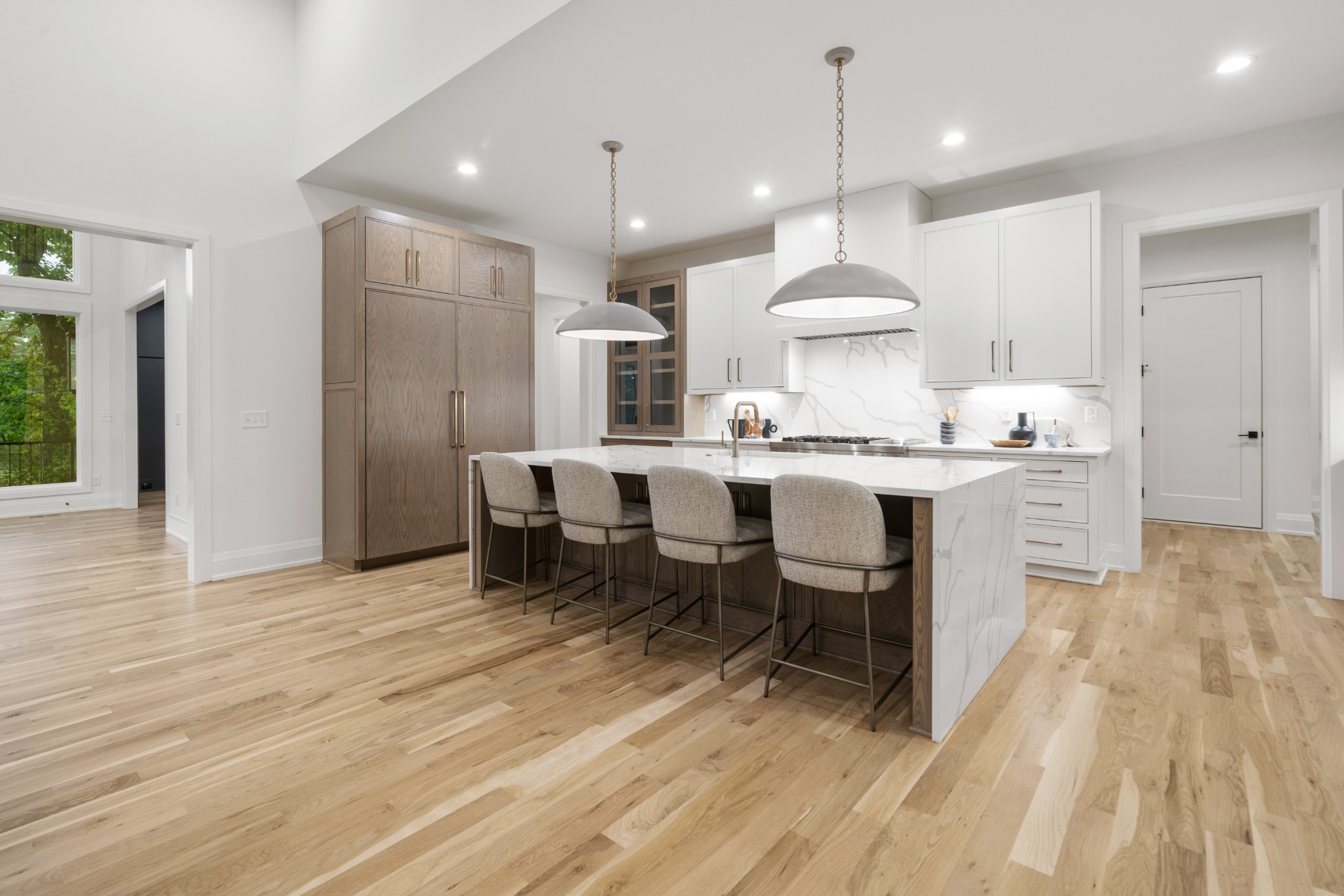 1323 Harding Place Nashville, TN 37215 - Photo 11 of 41 a kitchen with kitchen island a dining table chairs sink and wooden floor