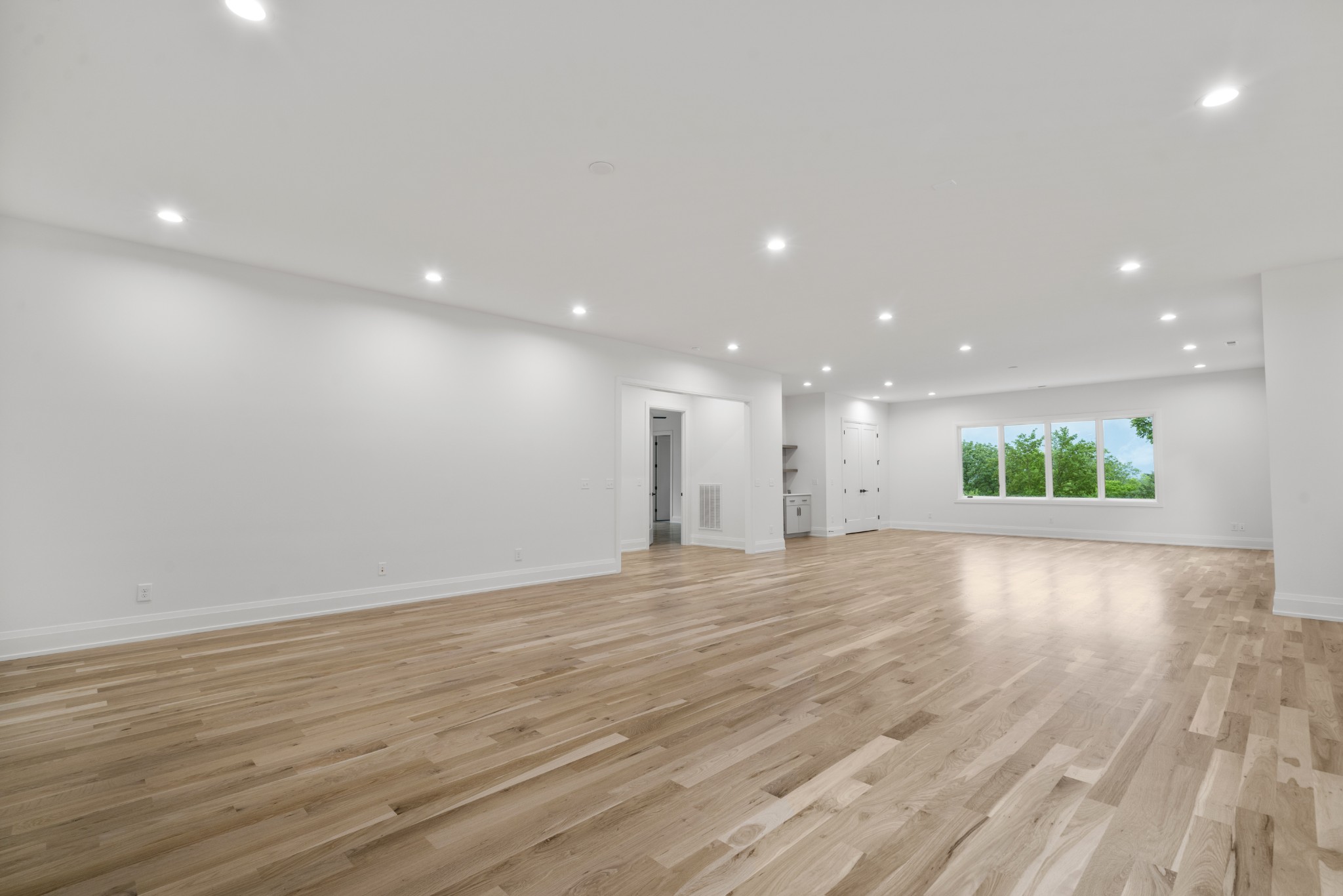 1323 Harding Place Nashville, TN 37215 - Photo 33 of 41 a view of an empty room with wooden floor and kitchen