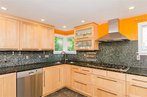 59 Wallis Road Brookline, MA 02467 - Photo 11 of 28 a kitchen with granite countertop a sink and a white cabinets