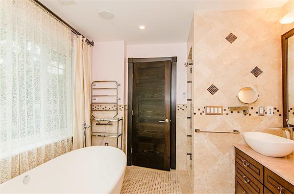 59 Wallis Road Brookline, MA 02467 - Photo 20 of 28 a bathroom with a granite countertop sink a mirror and shower
