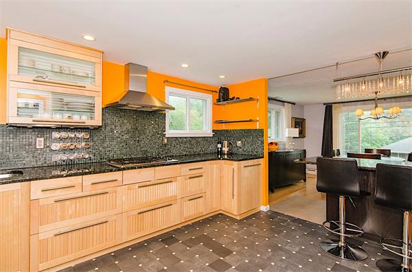 59 Wallis Road Brookline, MA 02467 - Photo 8 of 28 a kitchen with granite countertop sink cabinets and dining table