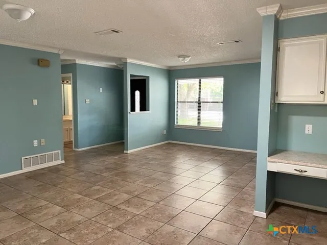 a view of a room that has a bed and a window in it