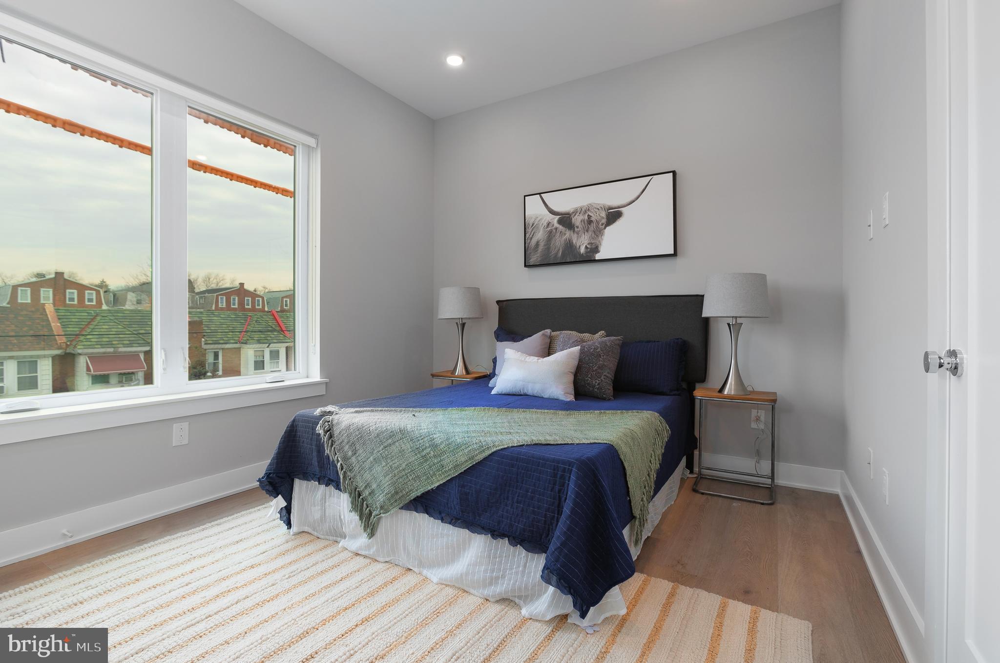 52 West Washington Lane, Unit 200 Philadelphia, PA 19144 - Photo 22 of 30 a bedroom with a large bed and a window